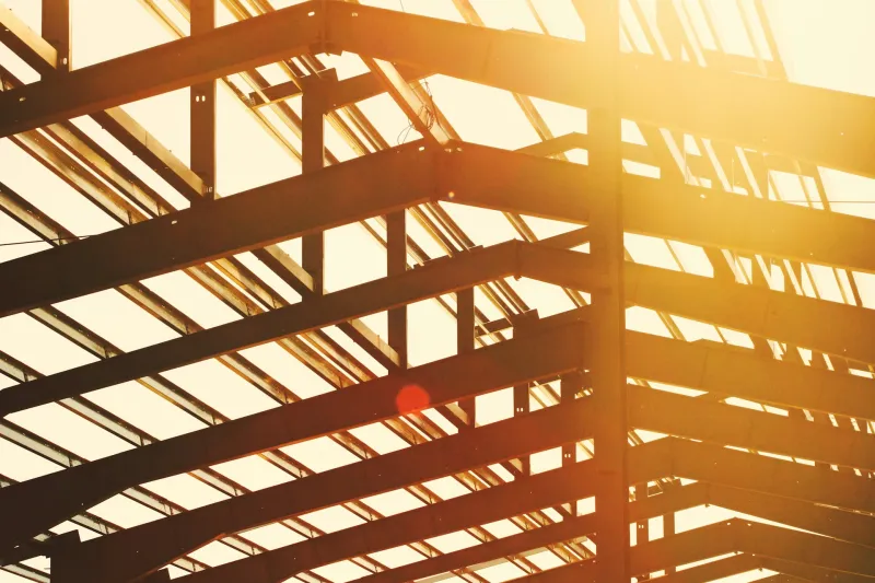 Steel roof beams and purlins against a bright sky
