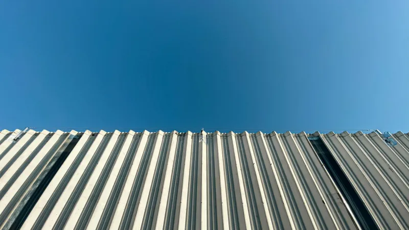 Profiled metal roof sheeting under a blue sky